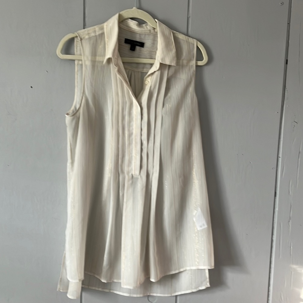 Large sleeveless top with gold stitching. Worn over camisole.